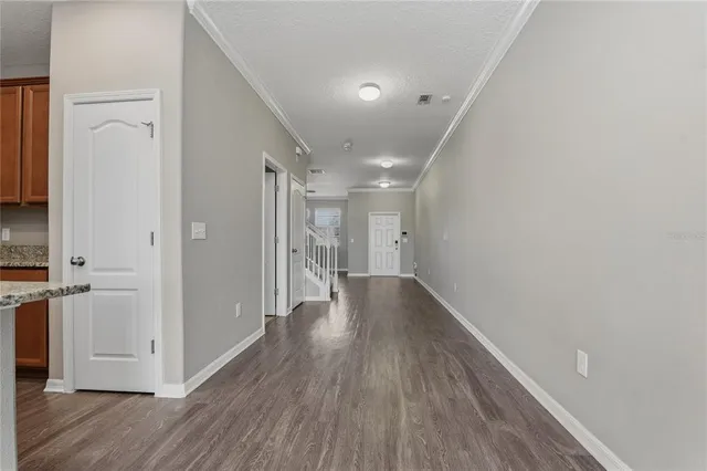 a view of hallway with wooden floor