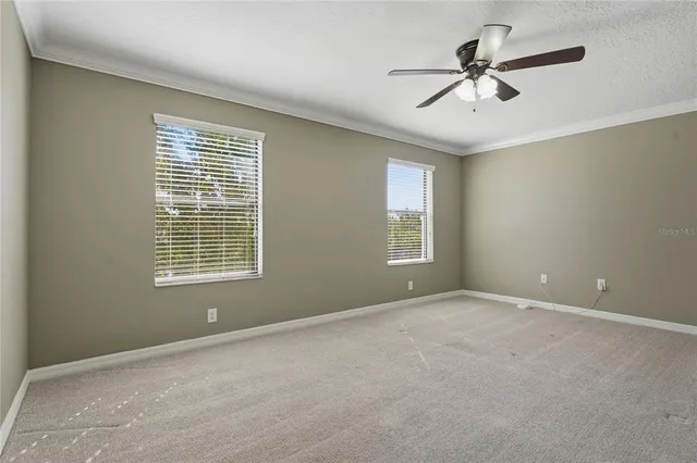 a view of an empty room with a ceiling fan