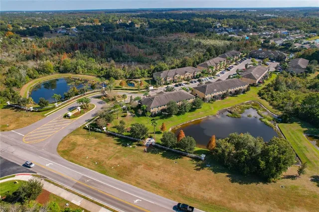 an aerial view of a house with a lake view