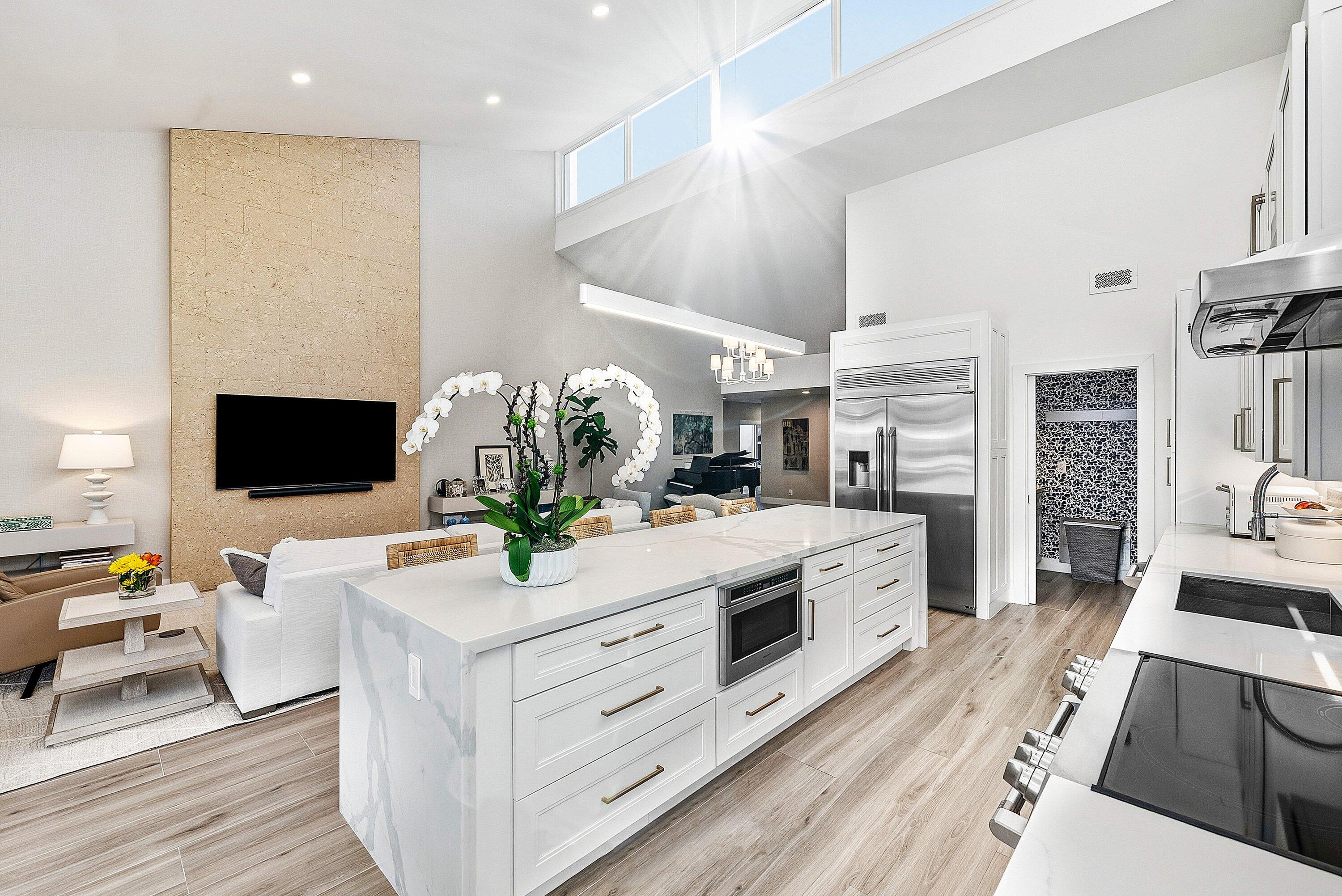 6110 North Ocean Boulevard, Unit 32 Ocean Ridge, FL 33435 - Photo 13 of 39 a living room with stainless steel appliances furniture a fireplace a flat screen tv and a kitchen view