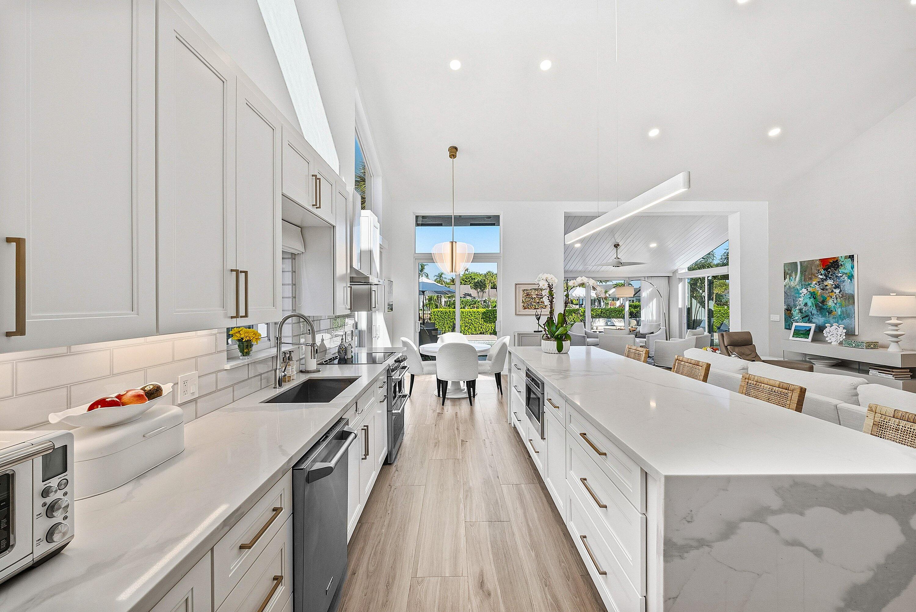 6110 North Ocean Boulevard, Unit 32 Ocean Ridge, FL 33435 - Photo 15 of 39 a large white kitchen with a large window
