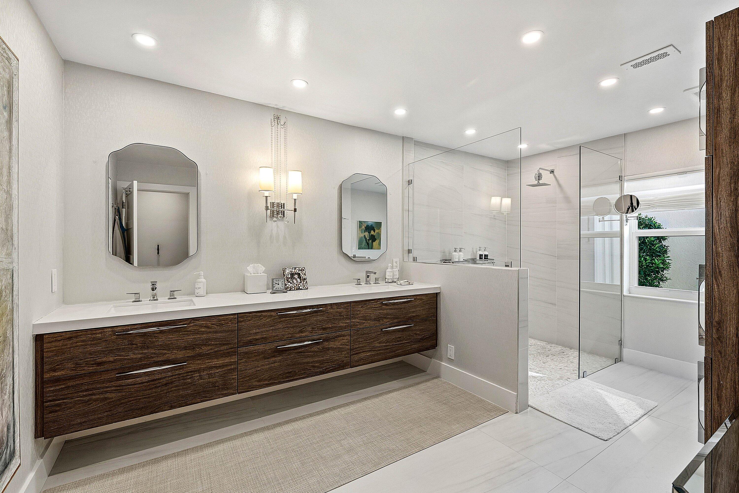 6110 North Ocean Boulevard, Unit 32 Ocean Ridge, FL 33435 - Photo 24 of 39 a spacious bathroom with double vanity and a mirror