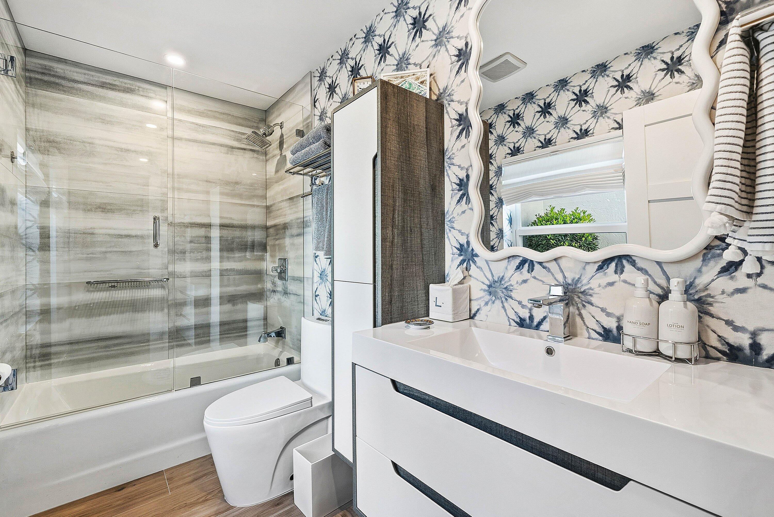 6110 North Ocean Boulevard, Unit 32 Ocean Ridge, FL 33435 - Photo 30 of 39 a bathroom with a sink a toilet and shower