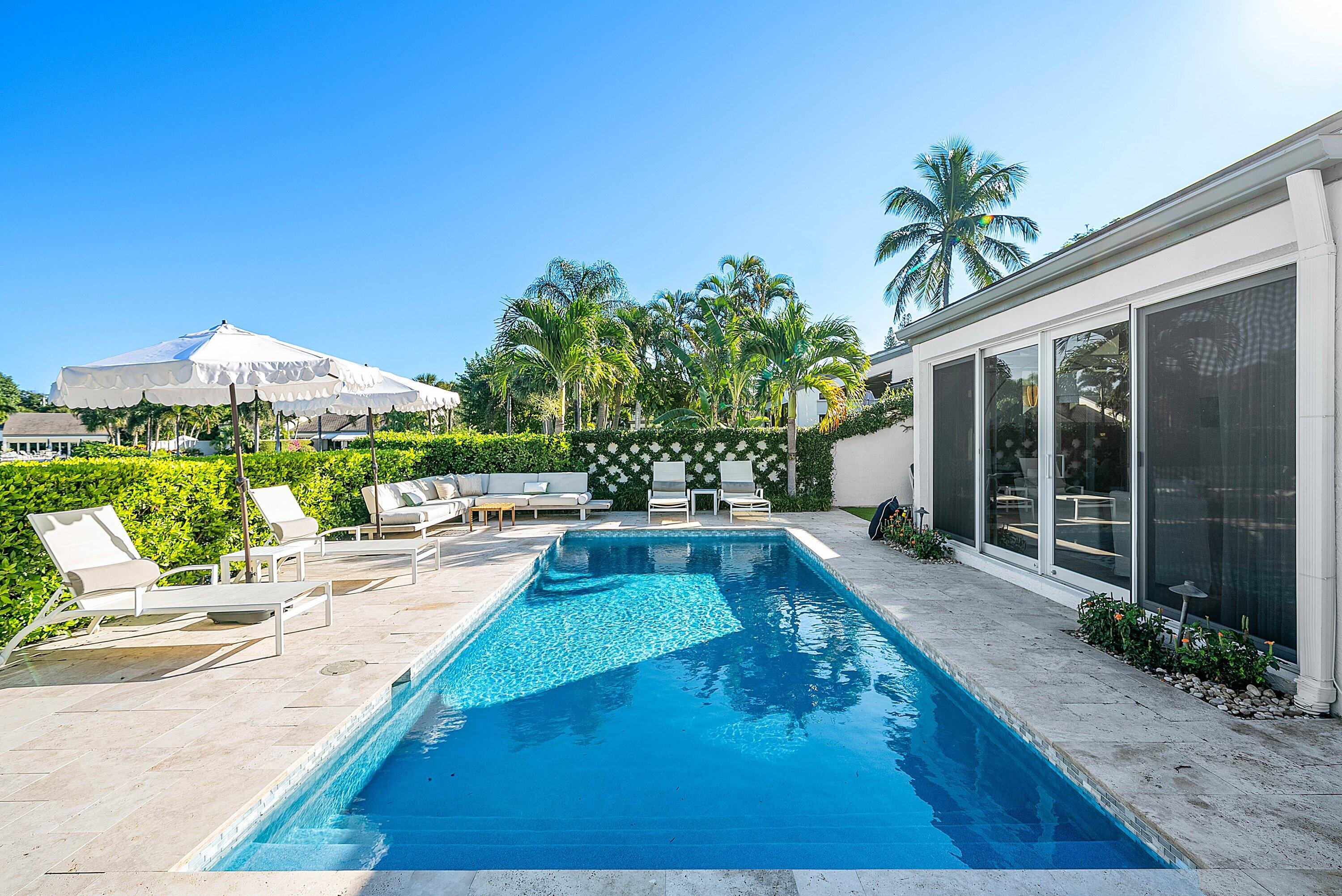 6110 North Ocean Boulevard, Unit 32 Ocean Ridge, FL 33435 - Photo 3 of 39 a view of a house with backyard porch and garden