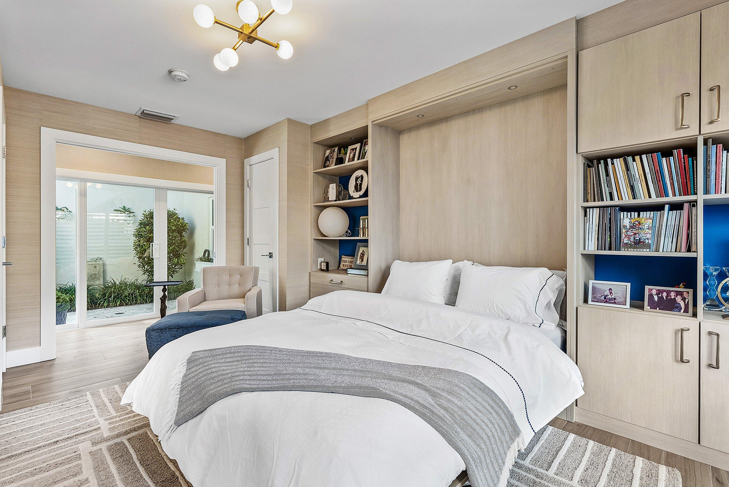 6110 North Ocean Boulevard, Unit 32 Ocean Ridge, FL 33435 - Photo 31 of 39 a bedroom with a large bed and a chandelier