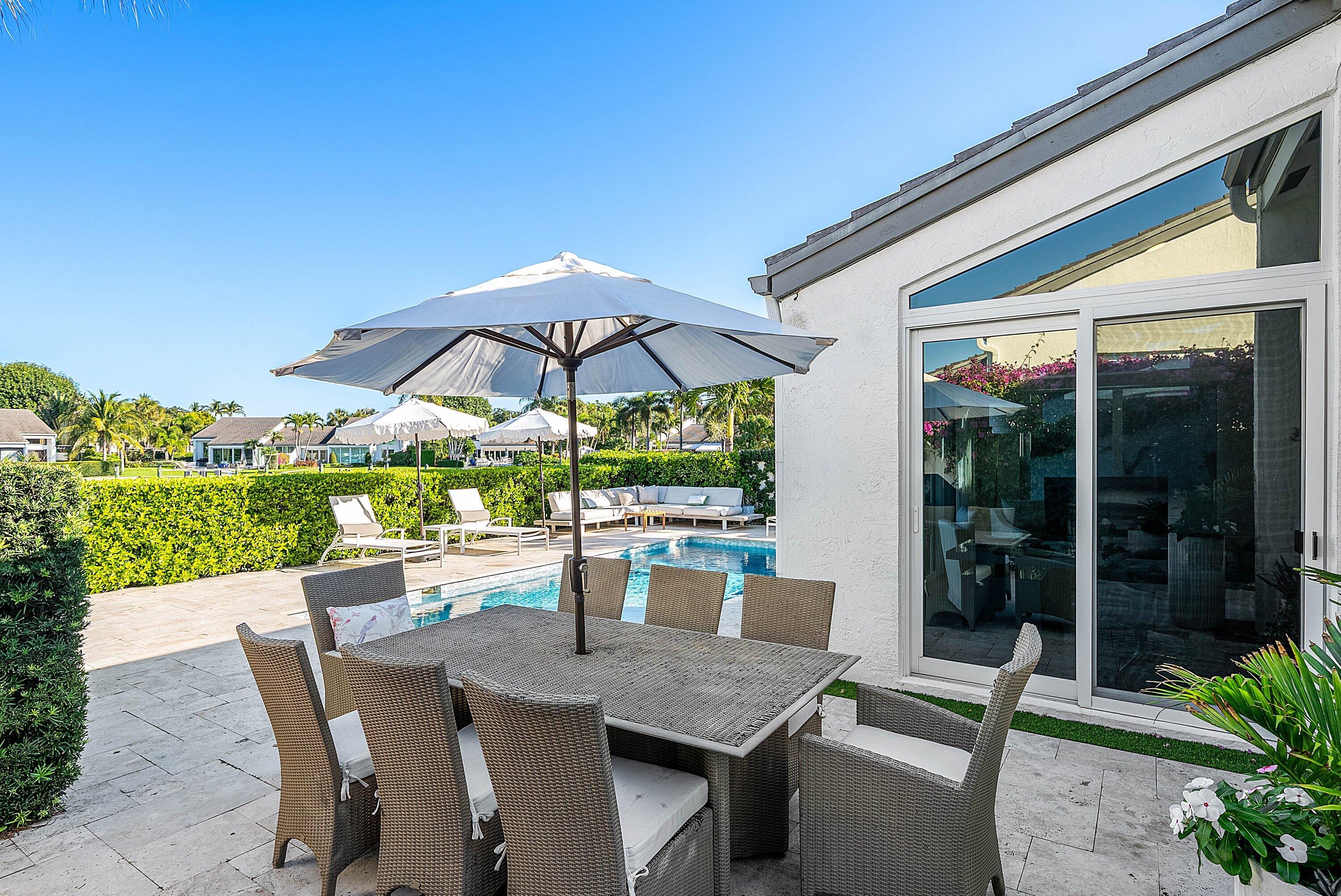 6110 North Ocean Boulevard, Unit 32 Ocean Ridge, FL 33435 - Photo 33 of 39 a view of backyard with seating space and wooden floor