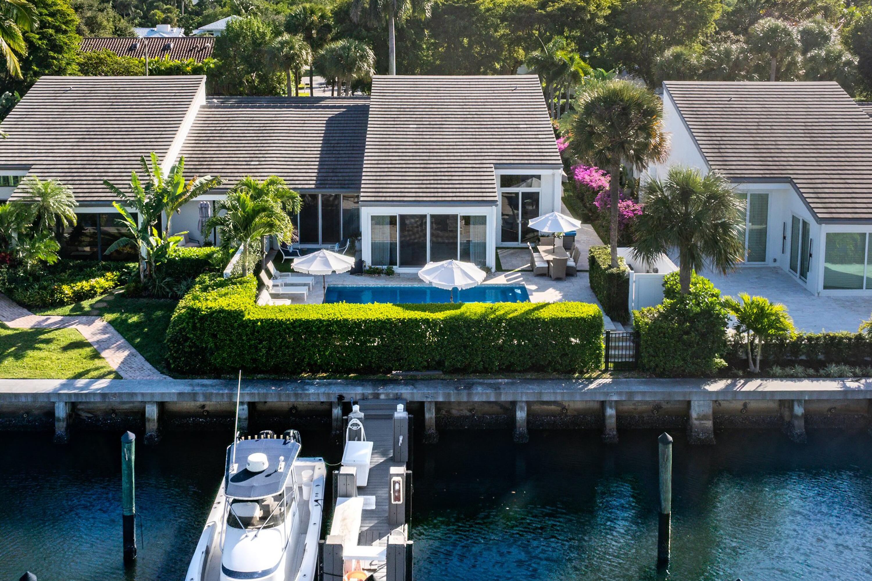 6110 North Ocean Boulevard, Unit 32 Ocean Ridge, FL 33435 - Photo 37 of 39 a aerial view of a house with swimming pool and large trees
