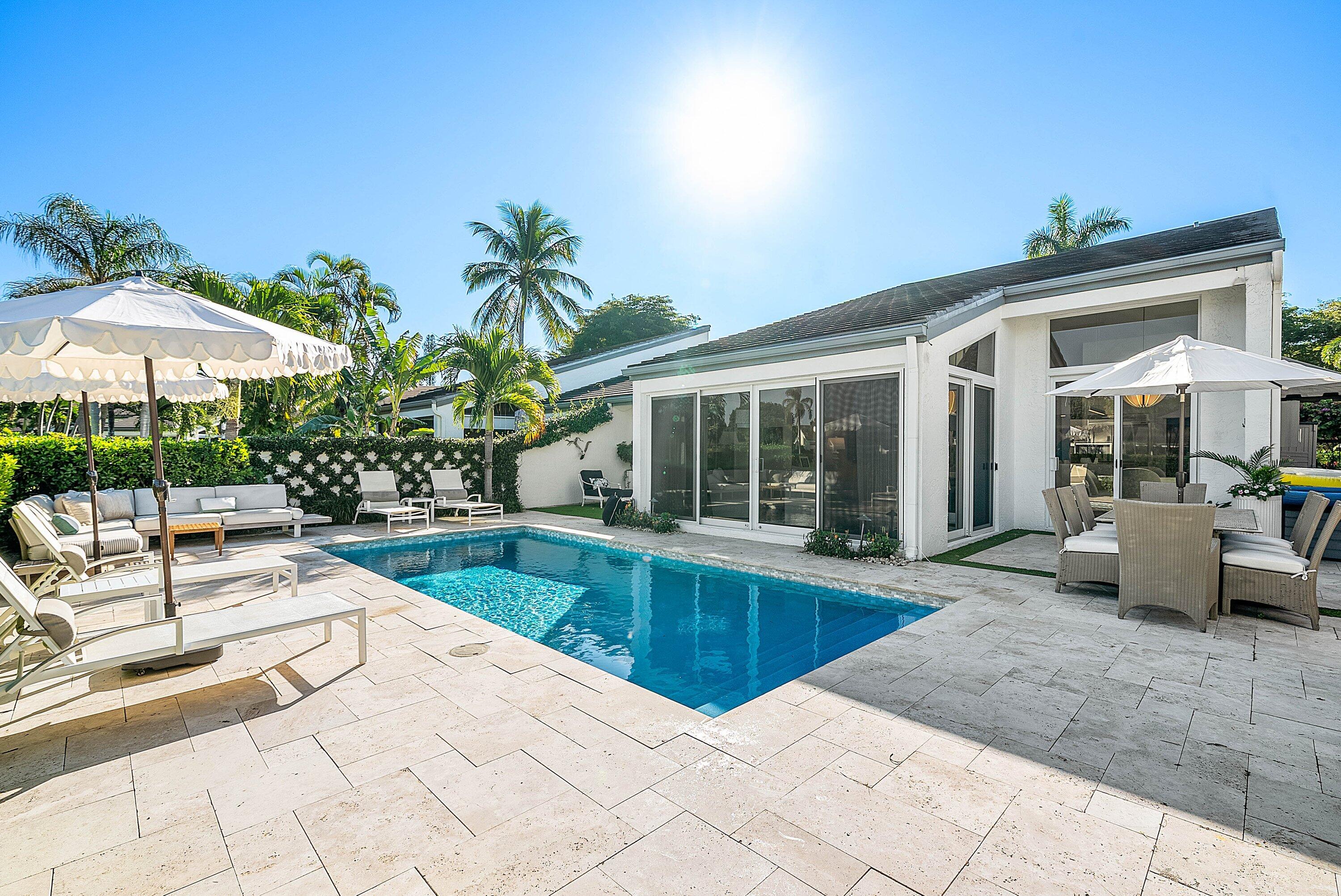 6110 North Ocean Boulevard, Unit 32 Ocean Ridge, FL 33435 - Photo 4 of 39 a view of a patio with a table and chairs under an umbrella