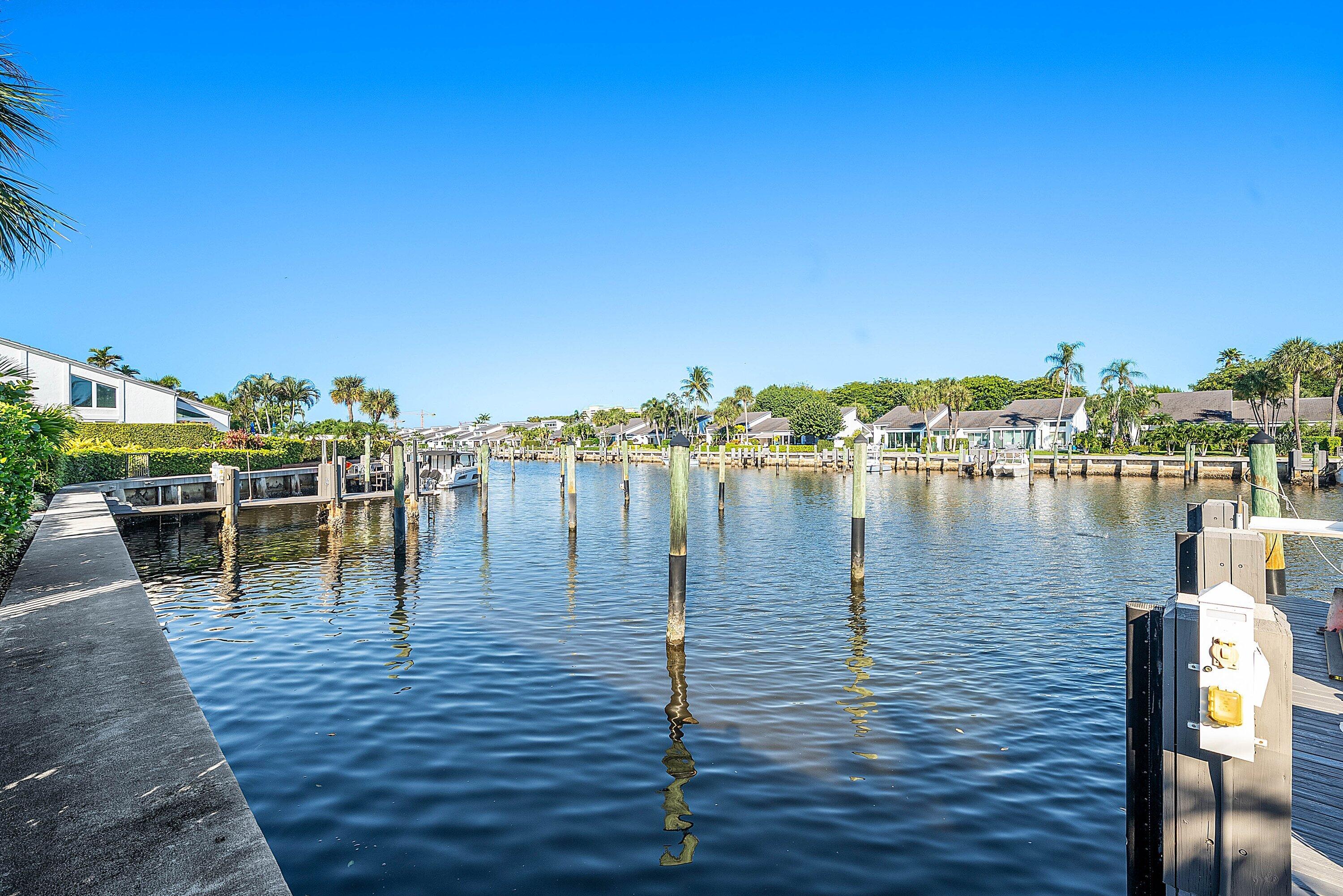 6110 North Ocean Boulevard, Unit 32 Ocean Ridge, FL 33435 - Photo 5 of 39 a view of a lake with boats and trees in the background