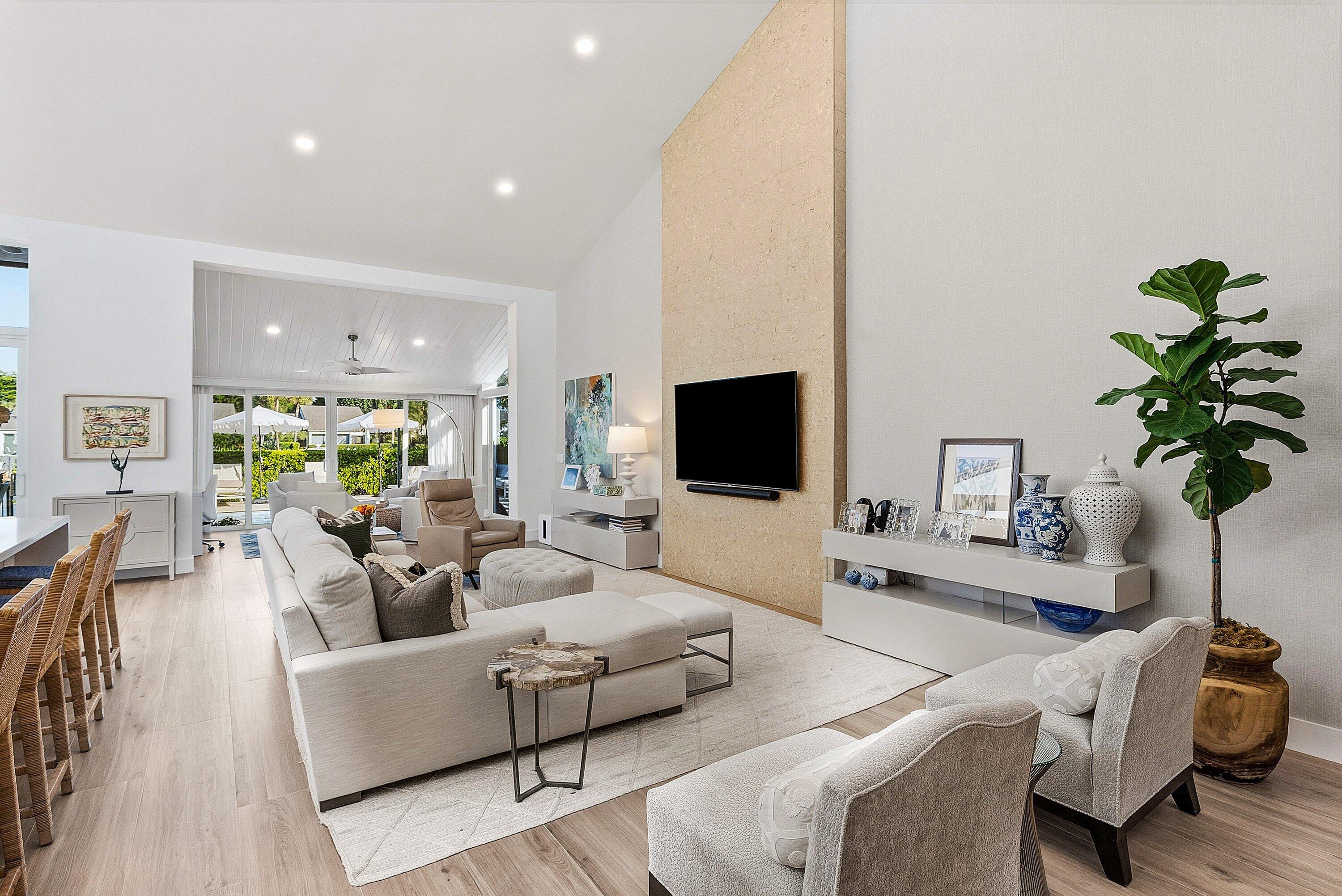 6110 North Ocean Boulevard, Unit 32 Ocean Ridge, FL 33435 - Photo 9 of 39 a living room with furniture a potted plant and a flat screen tv