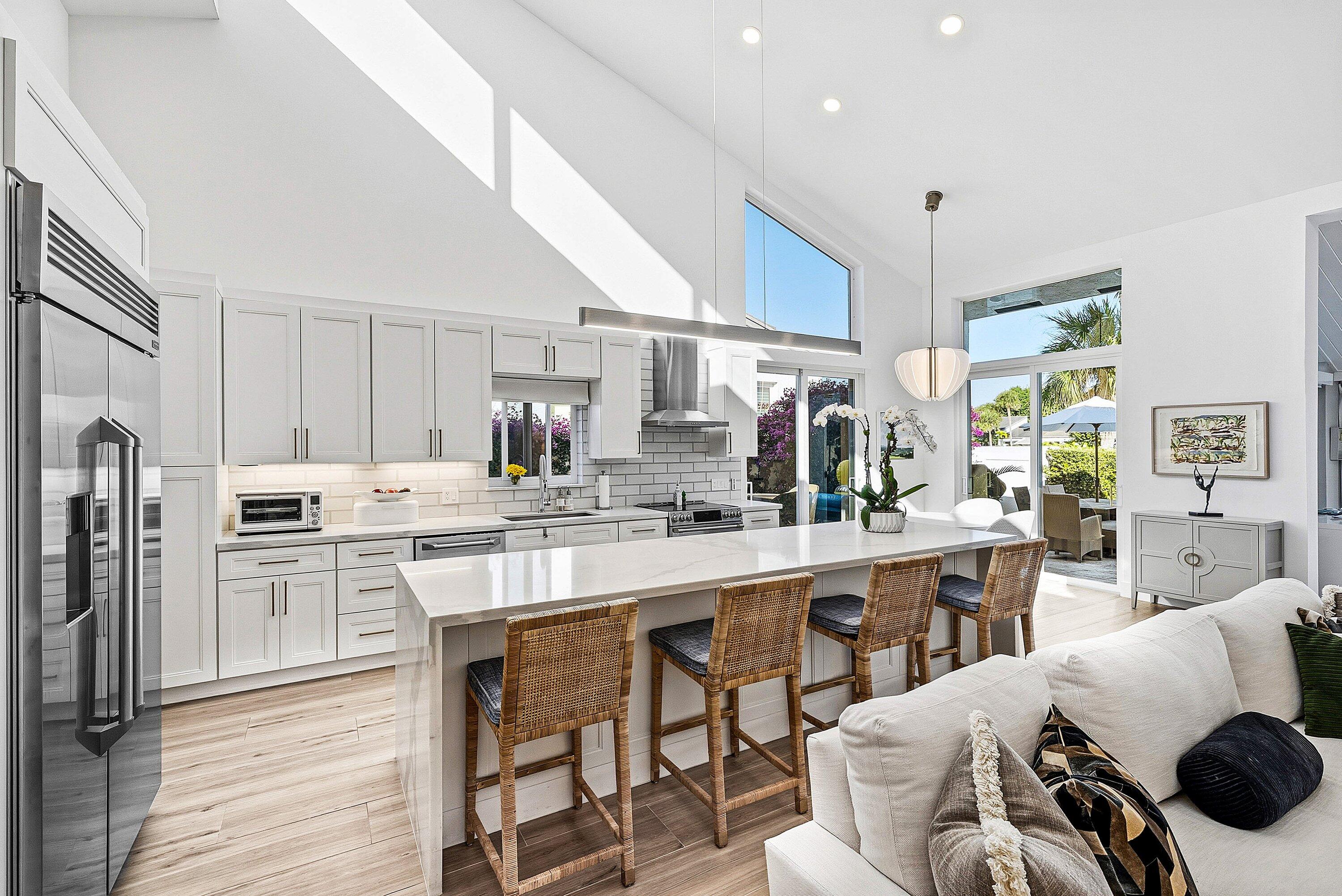 6110 North Ocean Boulevard, Unit 32 Ocean Ridge, FL 33435 - Photo 10 of 39 a kitchen with stainless steel appliances kitchen island granite countertop a sink and cabinets