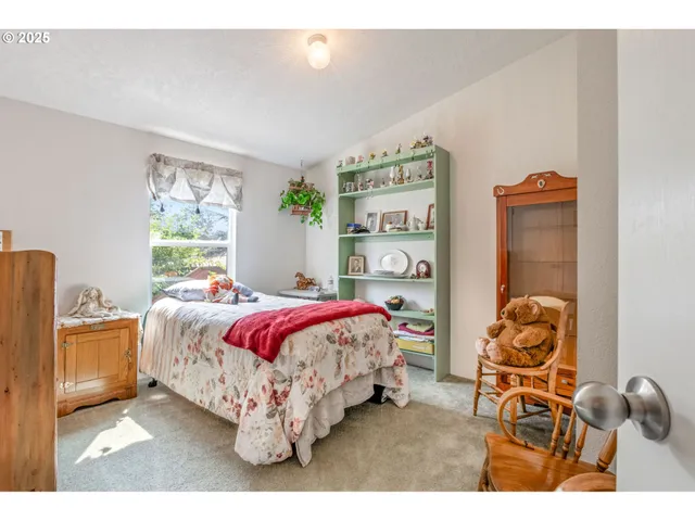 a bed sitting in a bedroom next to a window