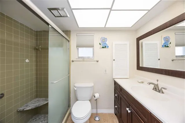 a bathroom with a sink a toilet and shower