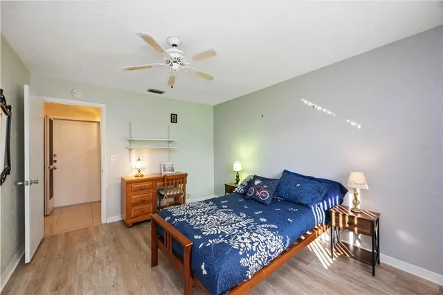 a bedroom with a bed and wooden floor