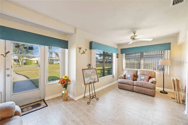 a living room with furniture and large windows