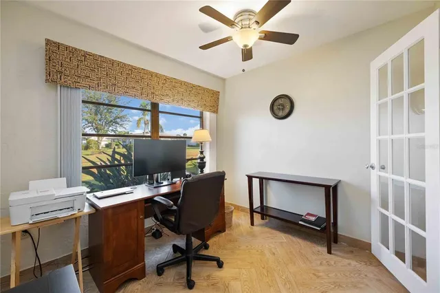a view of workspace with wooden floor windows