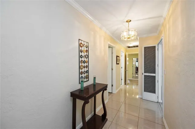 a view of a hallway with a chandelier and entryway