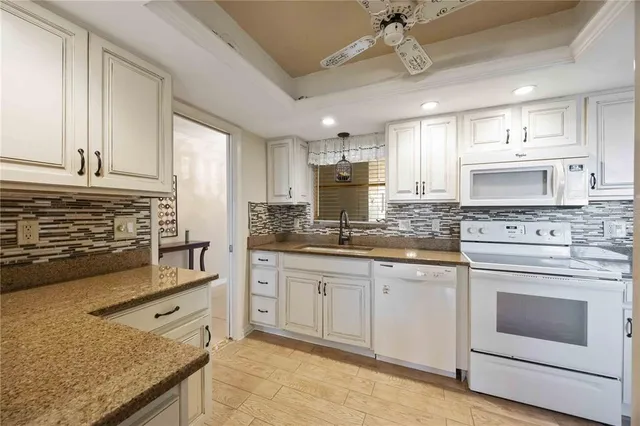a kitchen with stainless steel appliances granite countertop a stove sink and cabinets
