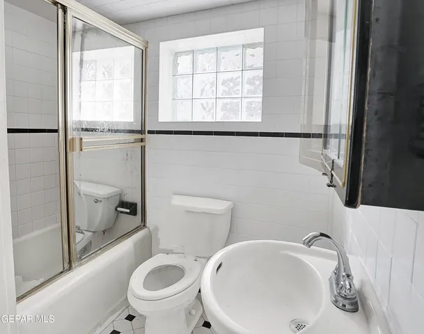 an empty room with wooden floor & closet area