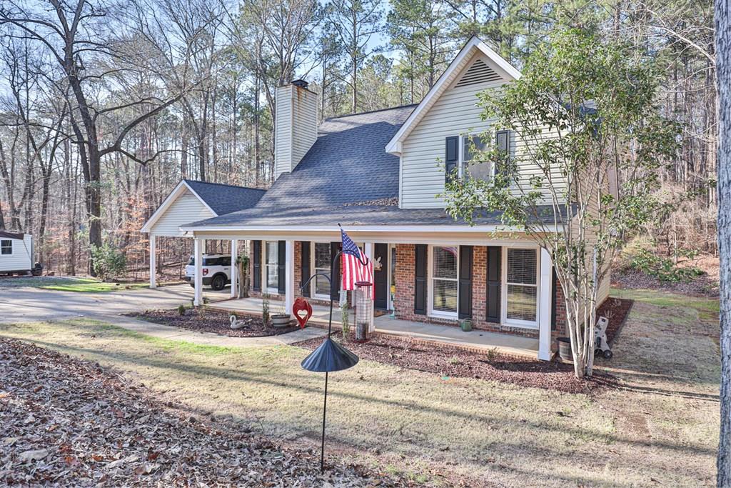 1236 Martin Road Hamilton, GA 31811 - Photo 1 of 33 a front view of a house with a yard and fountain