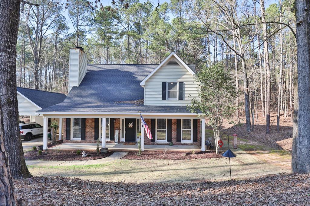 1236 Martin Road Hamilton, GA 31811 - Photo 2 of 33 a front view of a house with swimming pool and glass windows