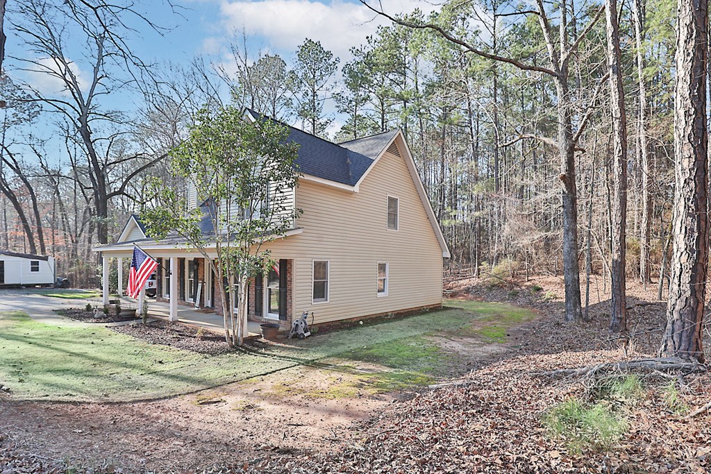 1236 Martin Road Hamilton, GA 31811 - Photo 4 of 33 a view of a white house with a yard and large trees
