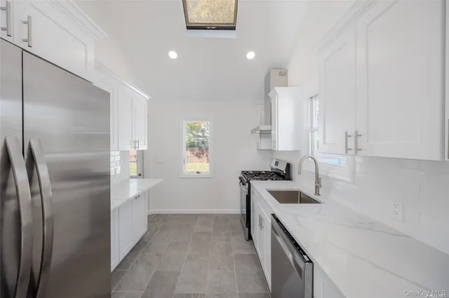 a kitchen with a sink stove and refrigerator