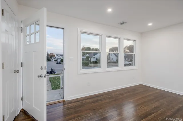 a view of an entryway with wooden floor