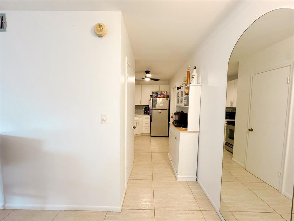 136 Northeast 19th Court, Unit 216F Wilton Manors, FL 33305 - Photo 11 of 26 a view of a hallway and a livingroom with furniture