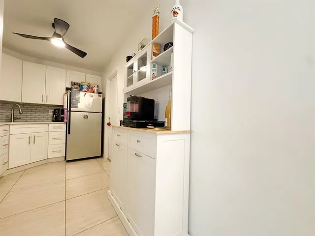 a kitchen with a refrigerator a microwave and sink