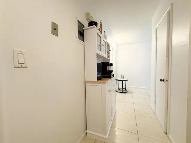 a walk in closet with kitchen view