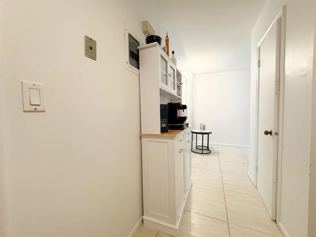 136 Northeast 19th Court, Unit 216F Wilton Manors, FL 33305 - Photo 16 of 26 a walk in closet with kitchen view