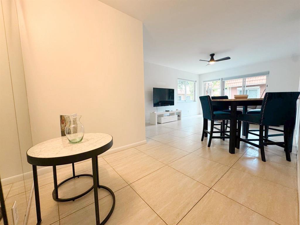 136 Northeast 19th Court, Unit 216F Wilton Manors, FL 33305 - Photo 18 of 26 a view of a dining room with furniture