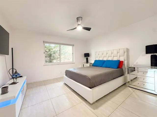 a bedroom with a large bed and a window