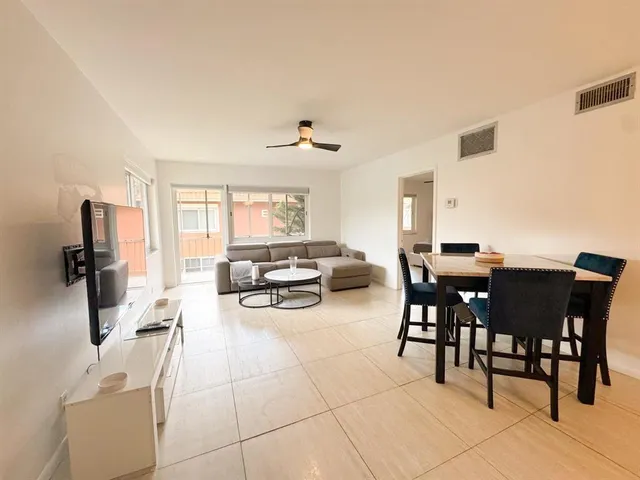 a view of a dining room with furniture and a window