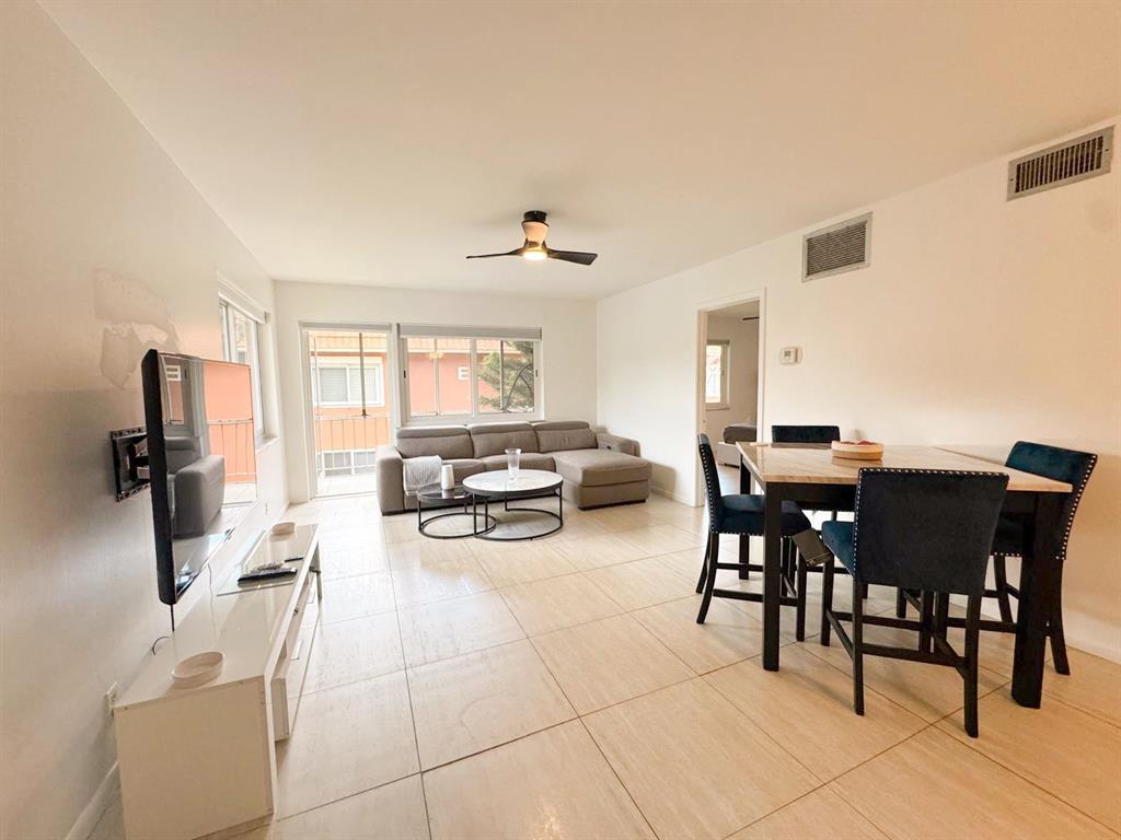 136 Northeast 19th Court, Unit 216F Wilton Manors, FL 33305 - Photo 2 of 26 a view of a dining room with furniture and a window