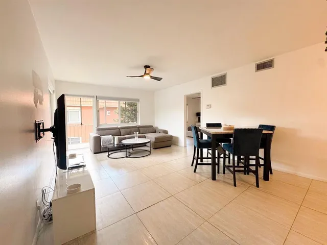 a view of a dining room with furniture and a floor to ceiling window