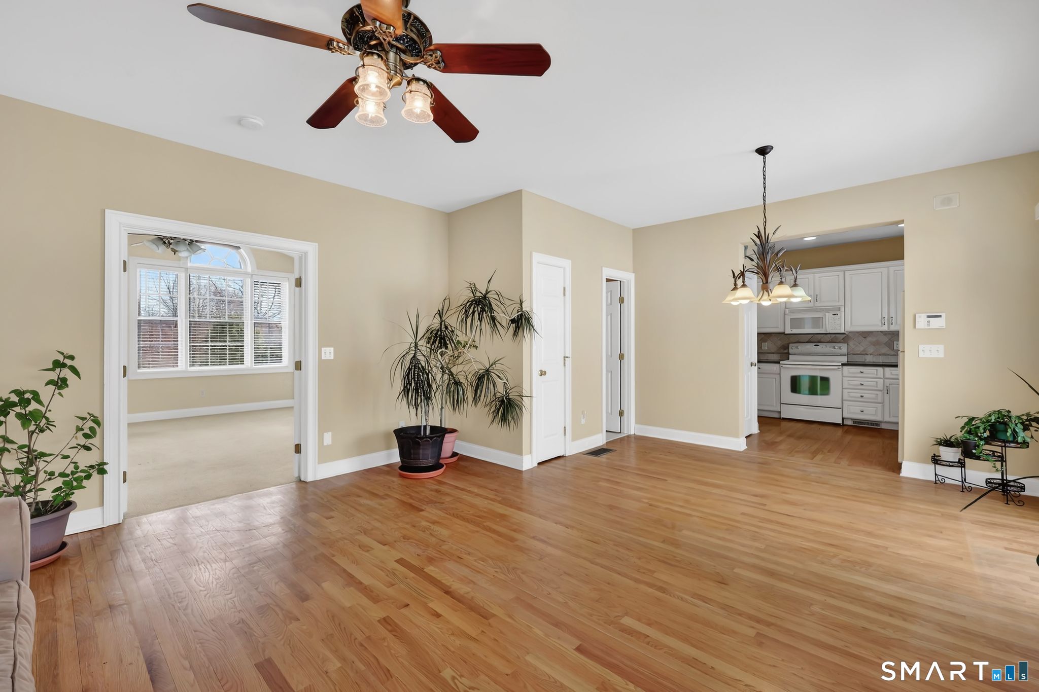 65 Trailside Drive Monroe, CT 06468 - Photo 17 of 39 a view of empty room with wooden floor and windows