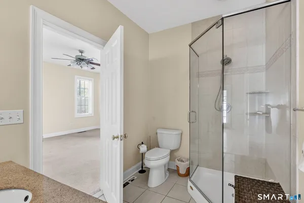 a bathroom with a toilet and a shower