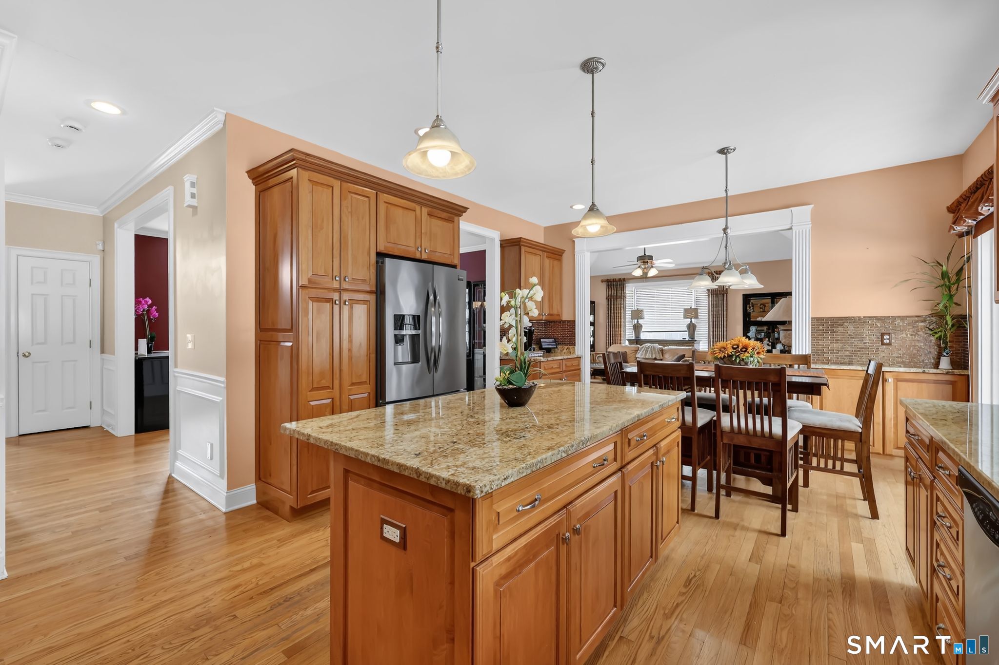 65 Trailside Drive Monroe, CT 06468 - Photo 7 of 39 a kitchen with a table chairs refrigerator and wooden floor