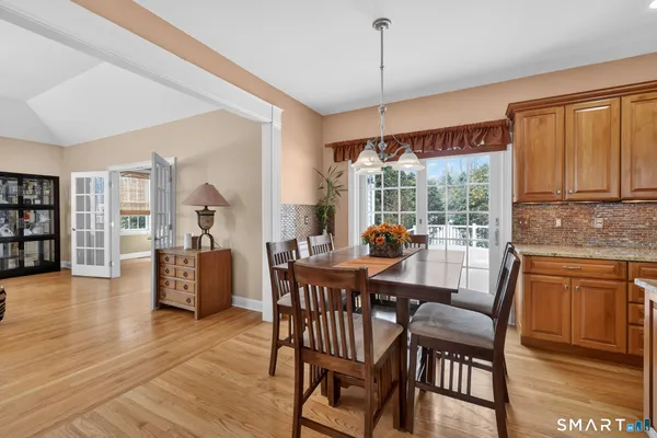 a view of a dining room with furniture window and wooden floor