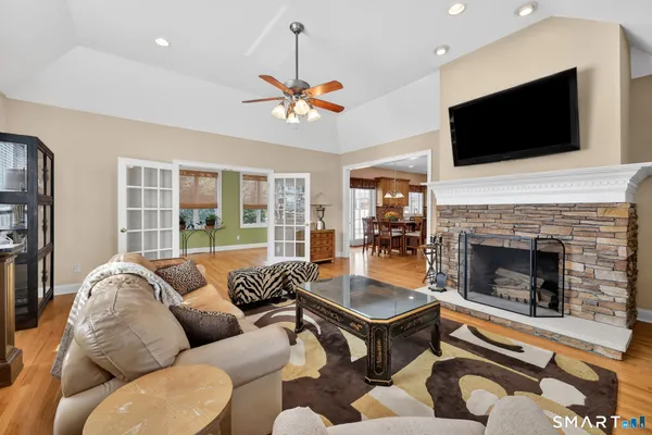 a living room with furniture a flat screen tv and a fireplace