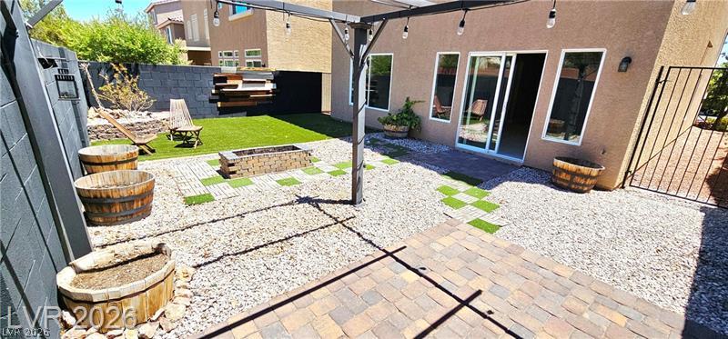 6302 Jackson Spring Road Las Vegas, NV 89118 - Photo 47 of 48 A well-appointed outdoor space features a fire pit, paver patio, and low-maintenance landscaping for effortless entertaining.