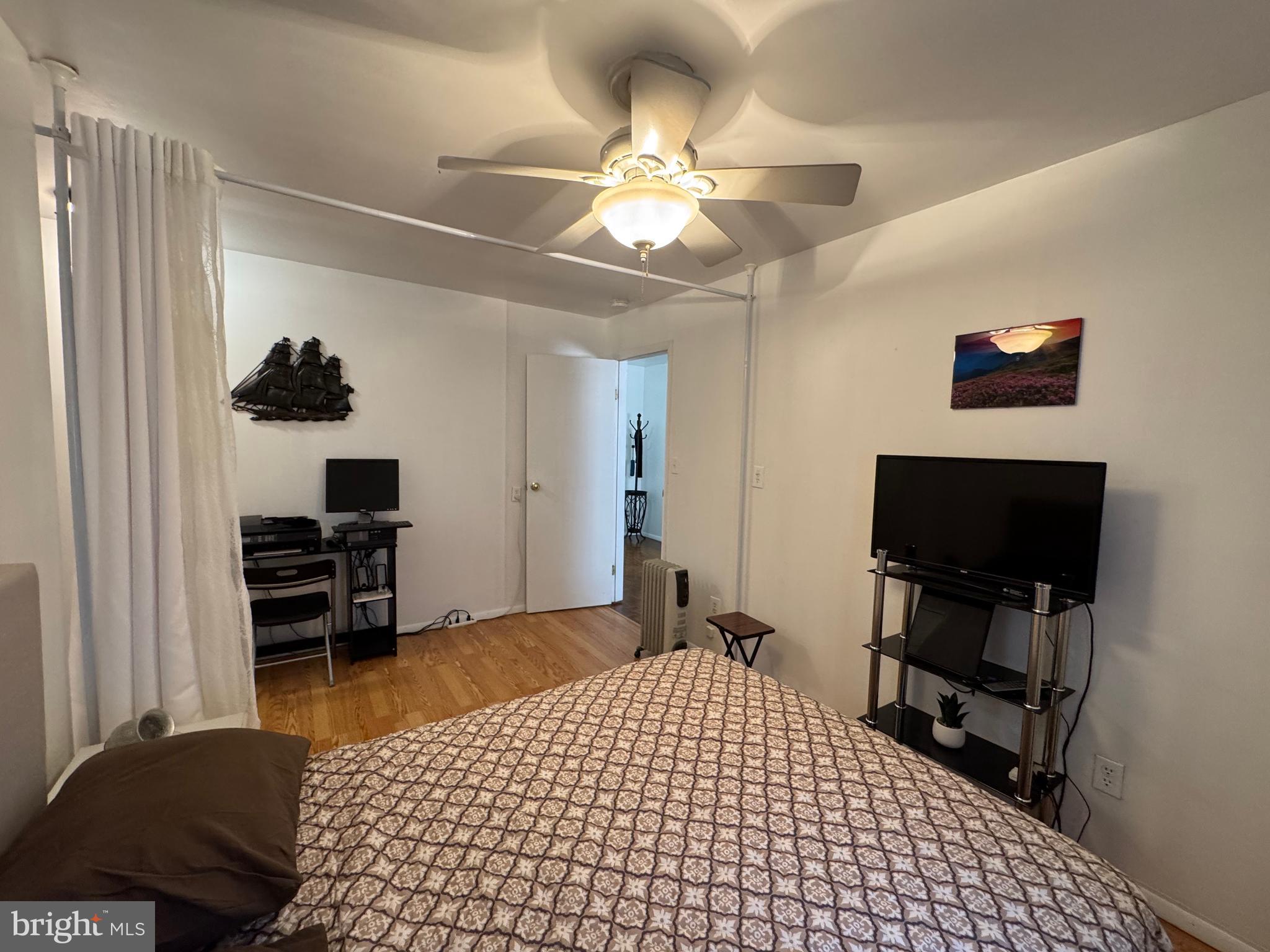 1517 Hill Road Reading, PA 19602 - Photo 9 of 12 a bedroom with a bed and a flat tv screen on a dresser
