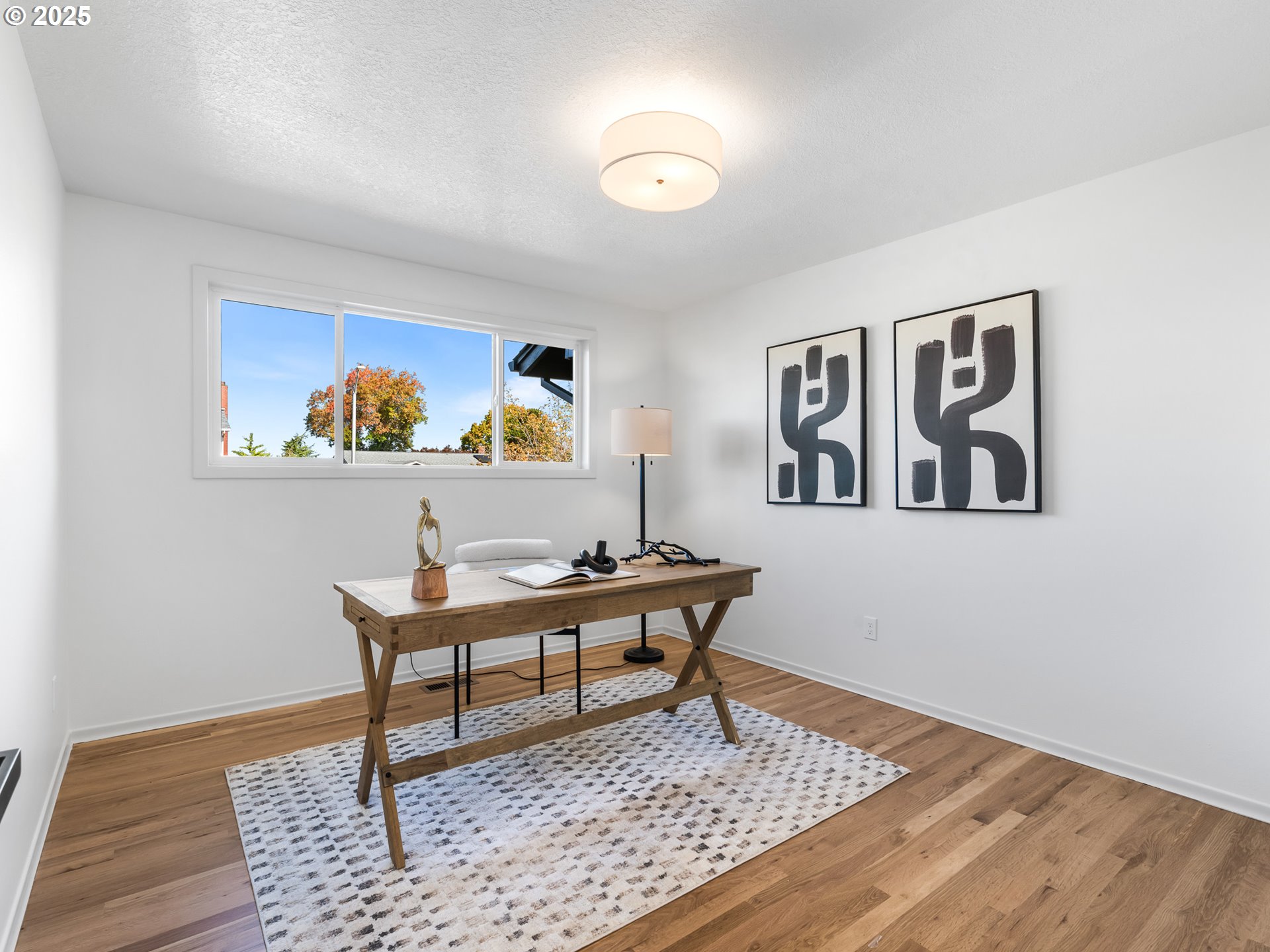 12942 Northeast Morris Street Portland, OR 97230 - Photo 12 of 28 a living room with a coffee table and paintings on the wall