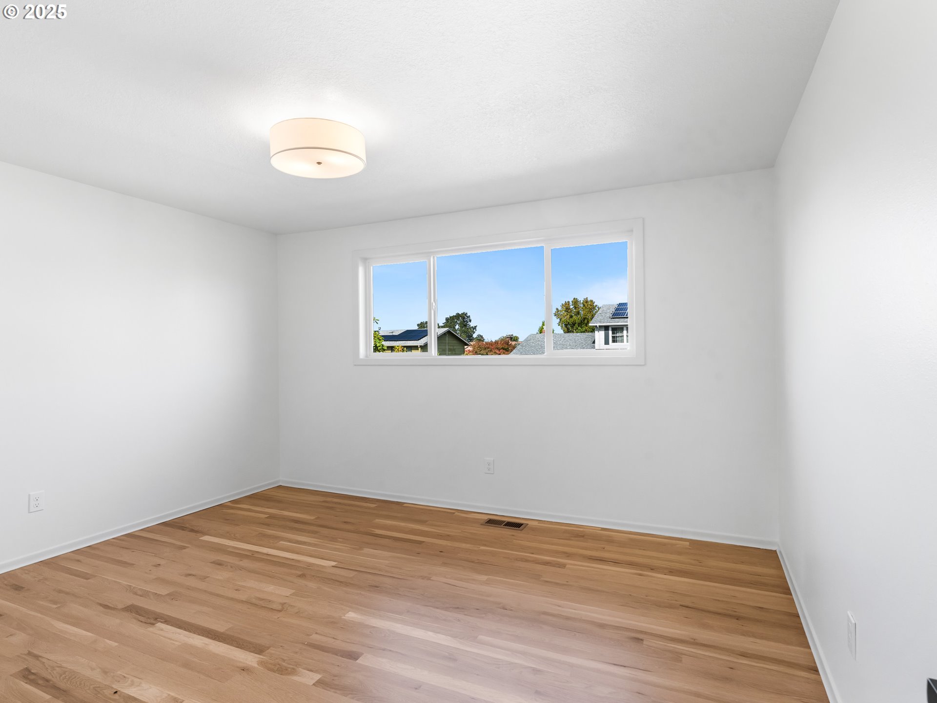 12942 Northeast Morris Street Portland, OR 97230 - Photo 15 of 28 a view of empty room with wooden floor