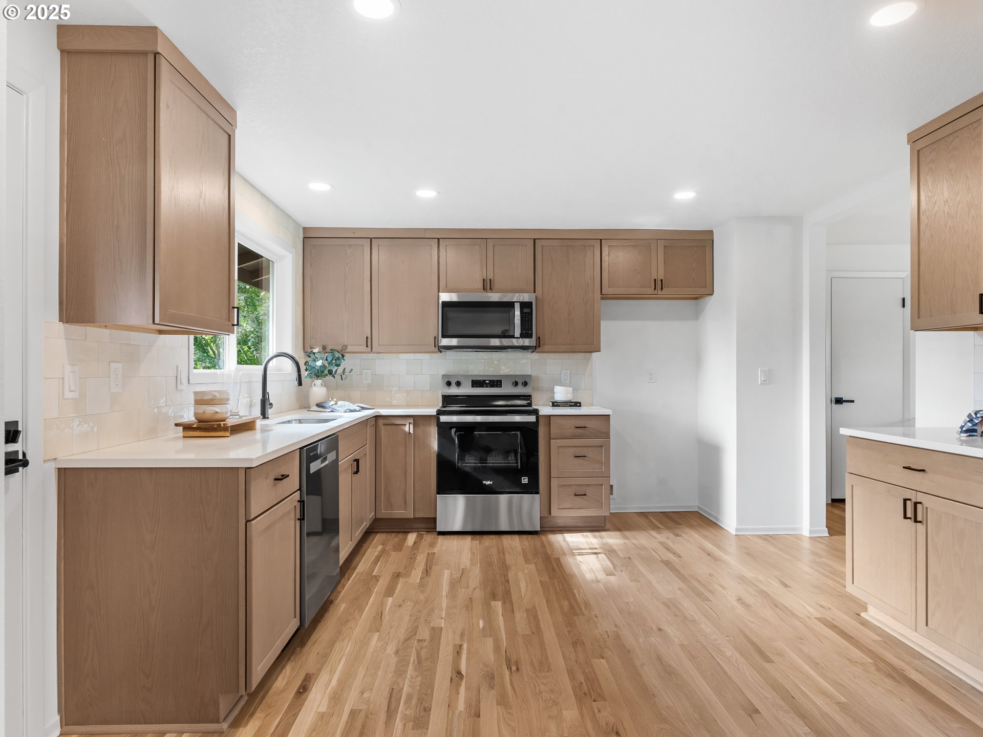 12942 Northeast Morris Street Portland, OR 97230 - Photo 6 of 28 a kitchen with sink a microwave and cabinets
