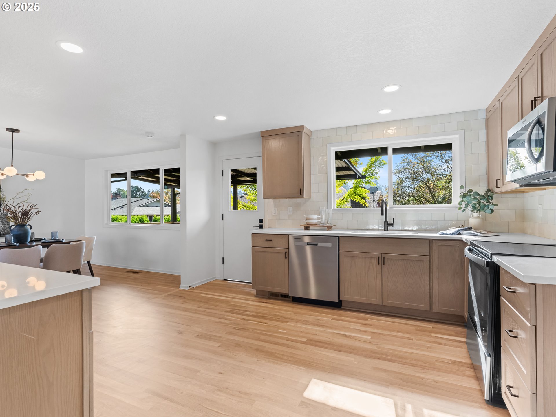 12942 Northeast Morris Street Portland, OR 97230 - Photo 7 of 28 a kitchen with stainless steel appliances a stove top oven