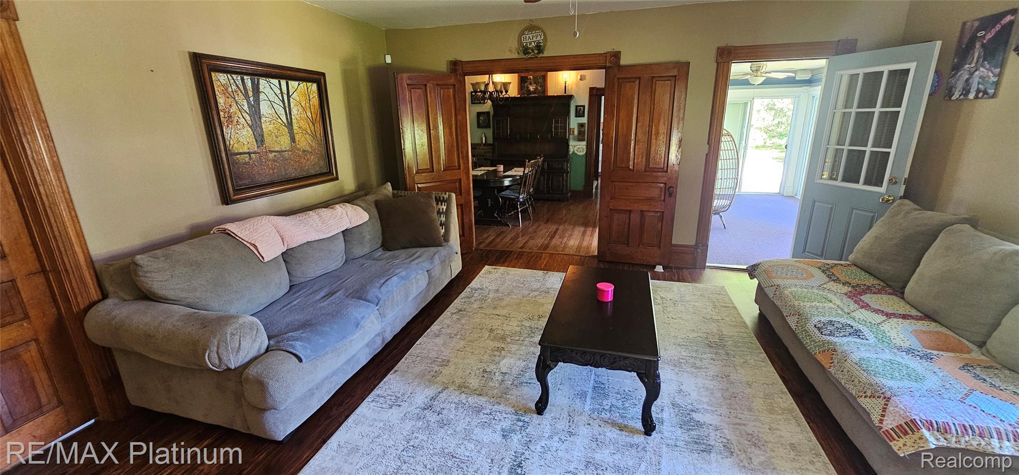 17140 Haggerty Road Belleville, MI 48111 - Photo 19 of 42 Living area featuring wood-finish flooring, light-toned walls, and a white patterned area rug