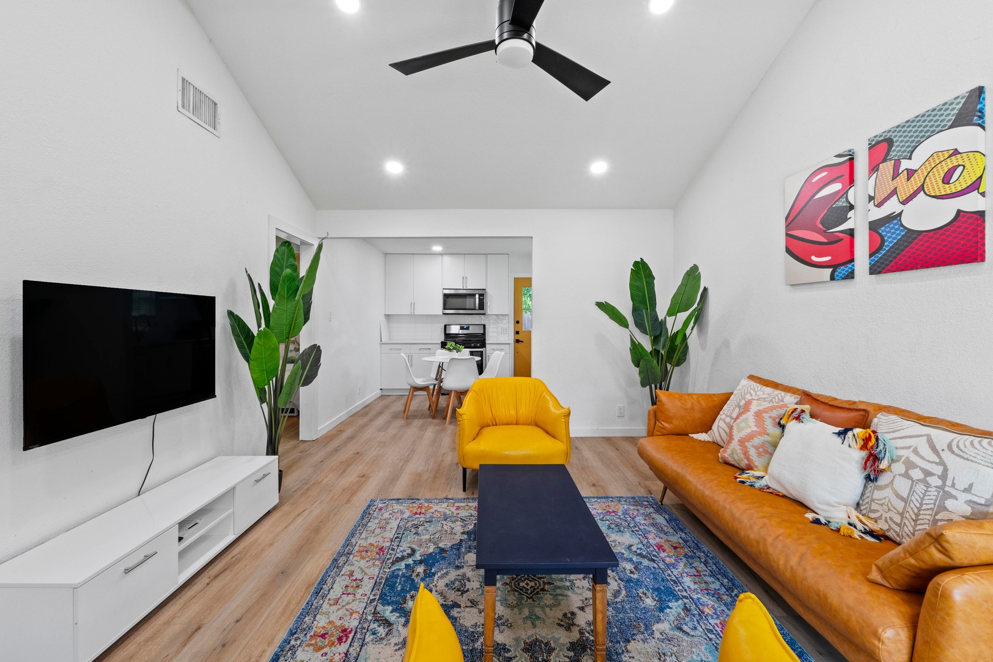 10601 Macmora Road, Unit B Austin, TX 78758 - Photo 4 of 22 Recessed lighting illuminates an open concept living area featuring durable hardwood flooring.